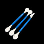 Three plastic sculpting tools with blue handles and white tips, arranged diagonally on a solid black background.