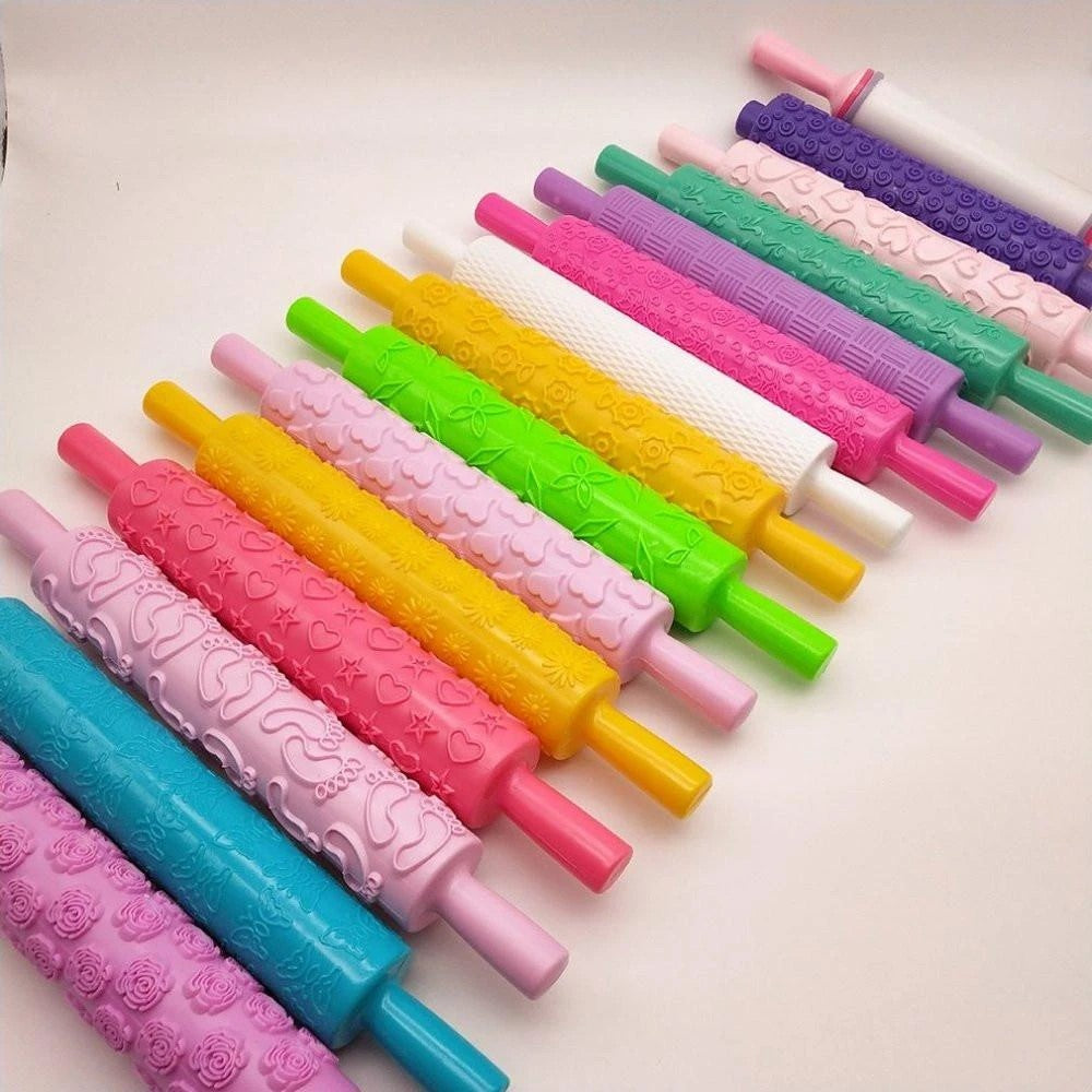 Embossed rolling pin creating decorative pattern on fondant