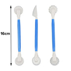 Three white and blue cleaning tools shown on a white background, with a vertical 16cm measurement marker on the left. The set includes a scrubber, a knife, and a dual-sided scrubber brush.