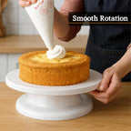 Rotating cake turntable with white plastic decorating surface