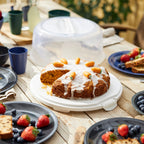 Round cake carrier protecting a decorated celebration cake