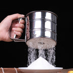 Stainless steel flour sifter with easy squeeze handle